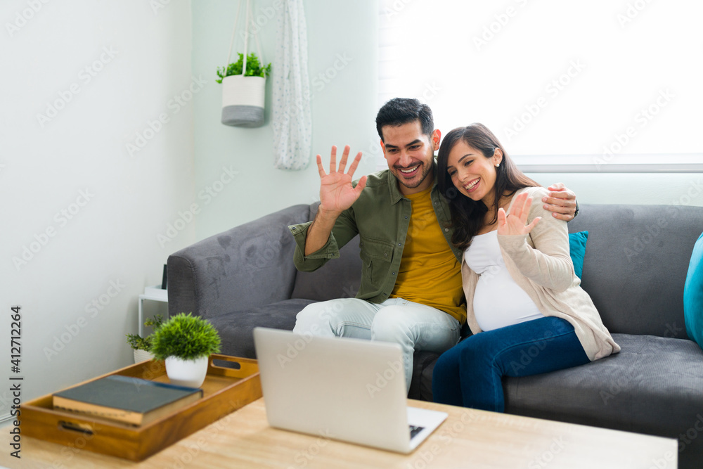 Latin man and pregnant woman during an online video call Latin man and pregnant woman during an online video call