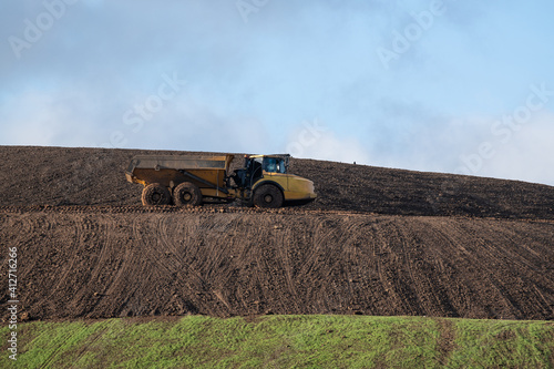 Dirty truck on a landfill recultivation area photo