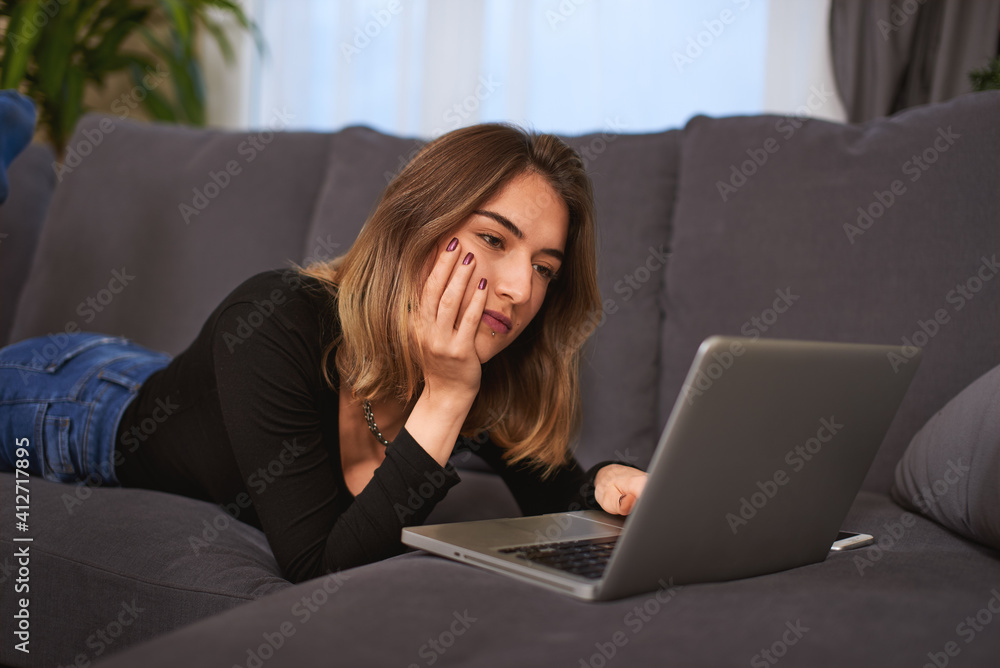 Teenager girl, with a computer, smartphone on a sofa in house. Teenager girl, with a computer, smartphone on a sofa in house.