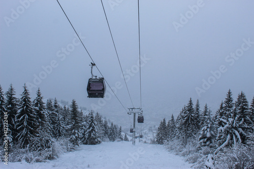 Cable car photographed from Trebevic in winter while it is snowing. Snow in winter on the mountain Trebevic. Sarajevo cable car in nature. Winter and snow. © Mahir