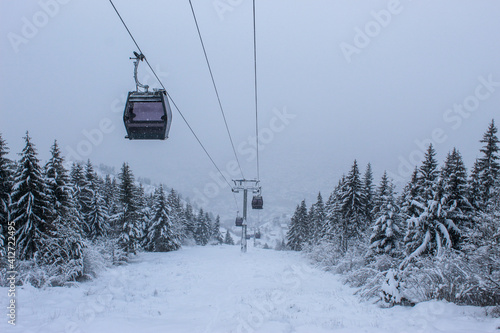 Cable car photographed from Trebevic in winter while it is snowing. Snow in winter on the mountain Trebevic. Sarajevo cable car in nature. Winter and snow. © Mahir