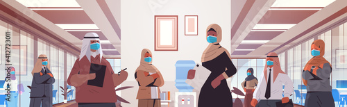 arabic businesspeople in protective masks keeping distance to prevent coronavirus pandemic arabic colleagues standing in office hallway horizontal portrait vector illustration