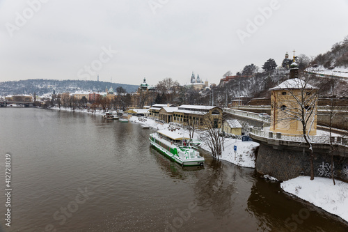 Snowy Prague Lesser Town with Prague Castle above River Vltava  Czech republic
