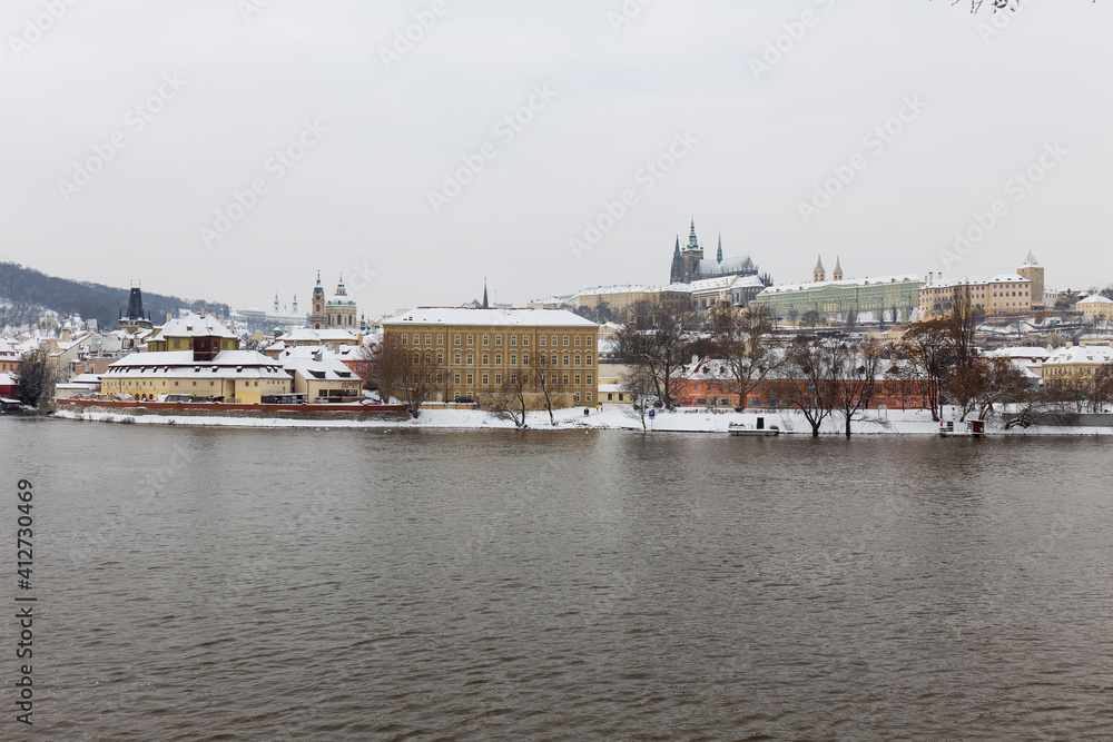 Snowy Prague Lesser Town with Prague Castle above River Vltava, Czech republic Snowy Prague Lesser Town with Prague Castle above River Vltava, Czech republic