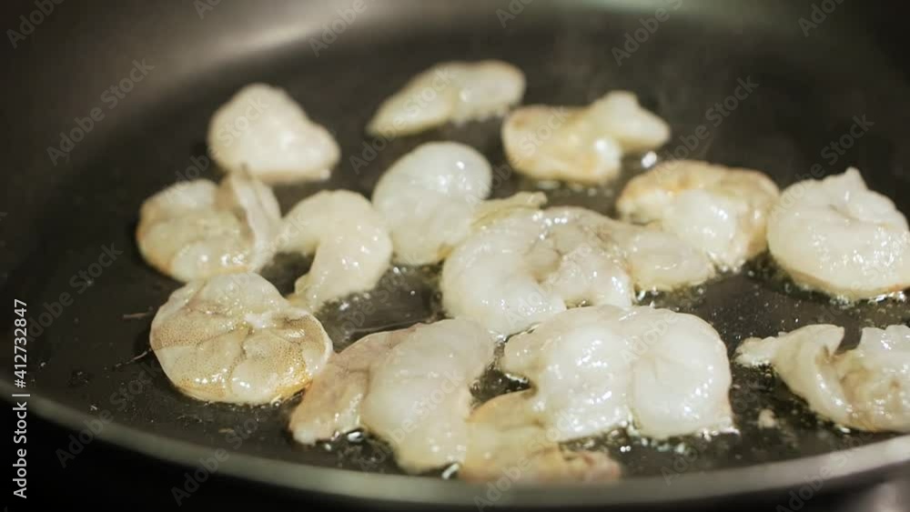 Frying shrimps in a pan with oil and spices slow motion Frying shrimps in a pan with oil and spices slow motion