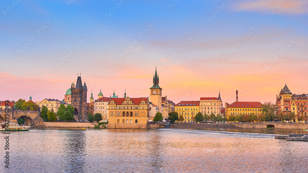 Travel destinations in Europe. Romantic Prague riverside. Panorama of Charles Bridge and historic buildings on Vltava river in Prague.