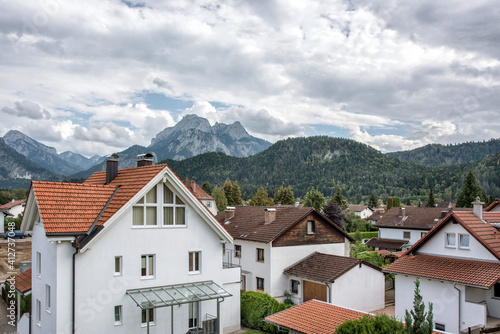A great view of the Alps and an old German cityl on background of mountains under cloudy sky. © Sergei