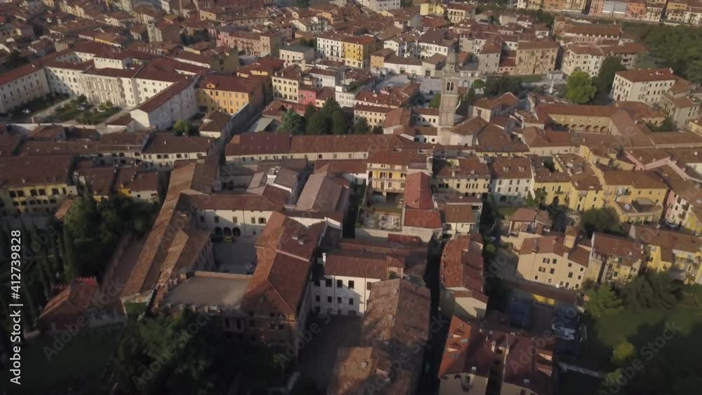 Panoramic evening aerial view of Verona ancient city. The drone approaches the river Adige, the typical Italian apartment rooftops and bridge Ponte Pietra. Video in 4K Panoramic evening aerial view of Verona ancient city. The drone approaches the river Adige, the typical Italian apartment rooftops and bridge Ponte Pietra. Video in 4K