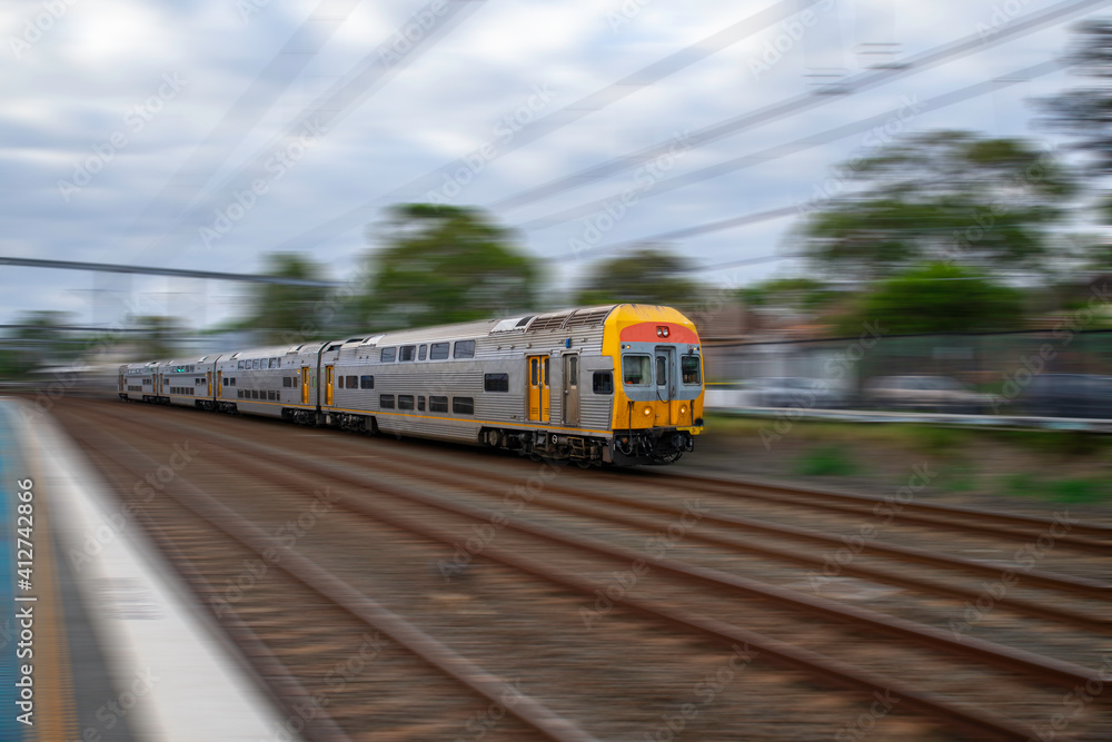 Commuter Train fast moving through a Station in Sydney NSW Australia