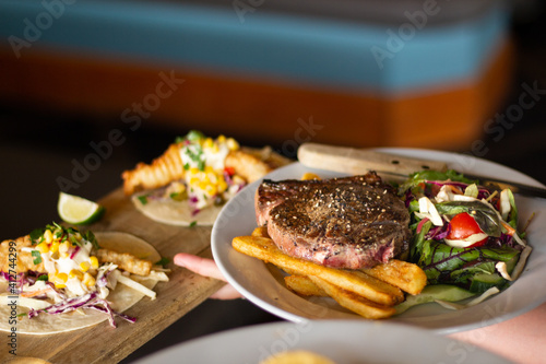 Rump Steak with fries / chips and salad on table in restaurant. Great on it's own, for social media or for a poster.