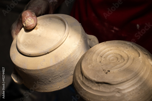 Ceramics on the elaboration process at a traditional factory at the small city of Raquira in Colombia photo