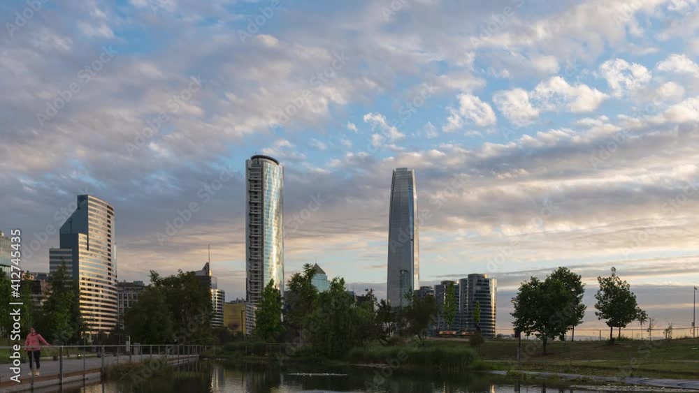 Time lapse at Santiago de Chile city on a beautiful cloudy day at sunset with orange and purple colors