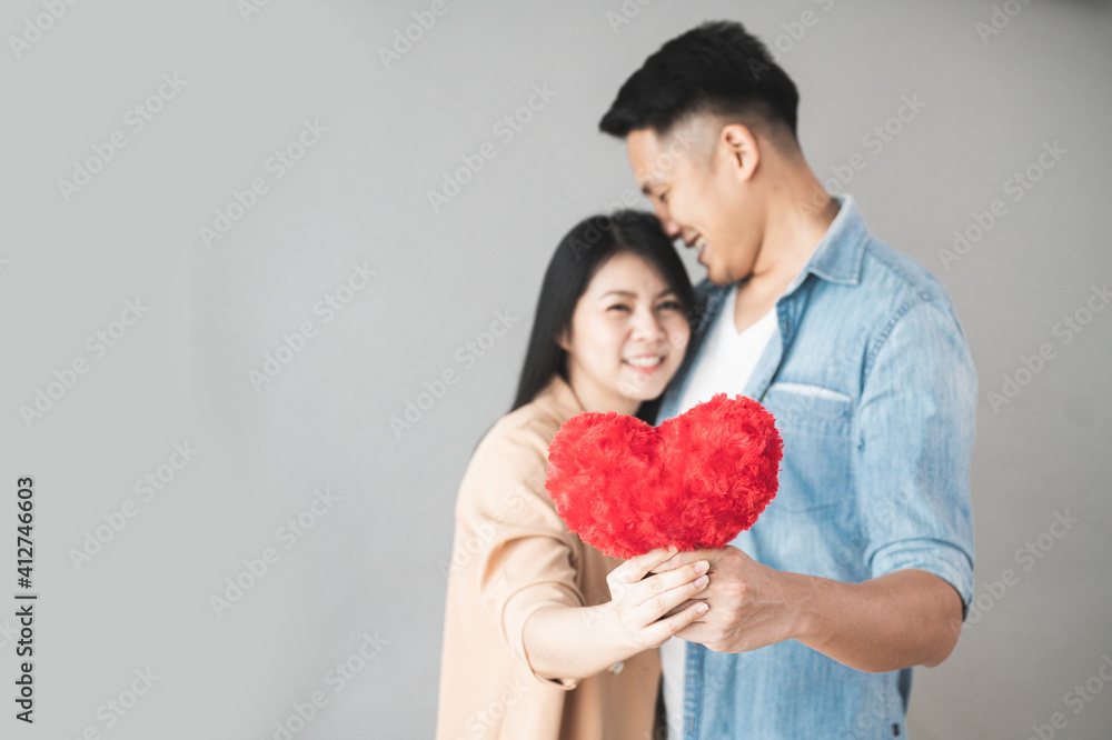 Selective focus Young Couple with red heart in love. Romantic Date Or valentine's day concept. Selective focus Young Couple with red heart in love. Romantic Date Or valentine's day concept.