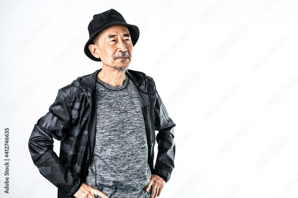 Cool fashion of an Asian old man in a gray t-shirt And a black coat He is wearing a black hat on his head. On a white background in the studio. Positive active senior, healthy and elderly concept Cool fashion of an Asian old man in a gray t-shirt And a black coat He is wearing a black hat on his head. On a white background in the studio. Positive active senior, healthy and elderly concept