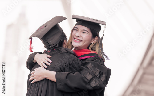 Two asian women happy with graduation