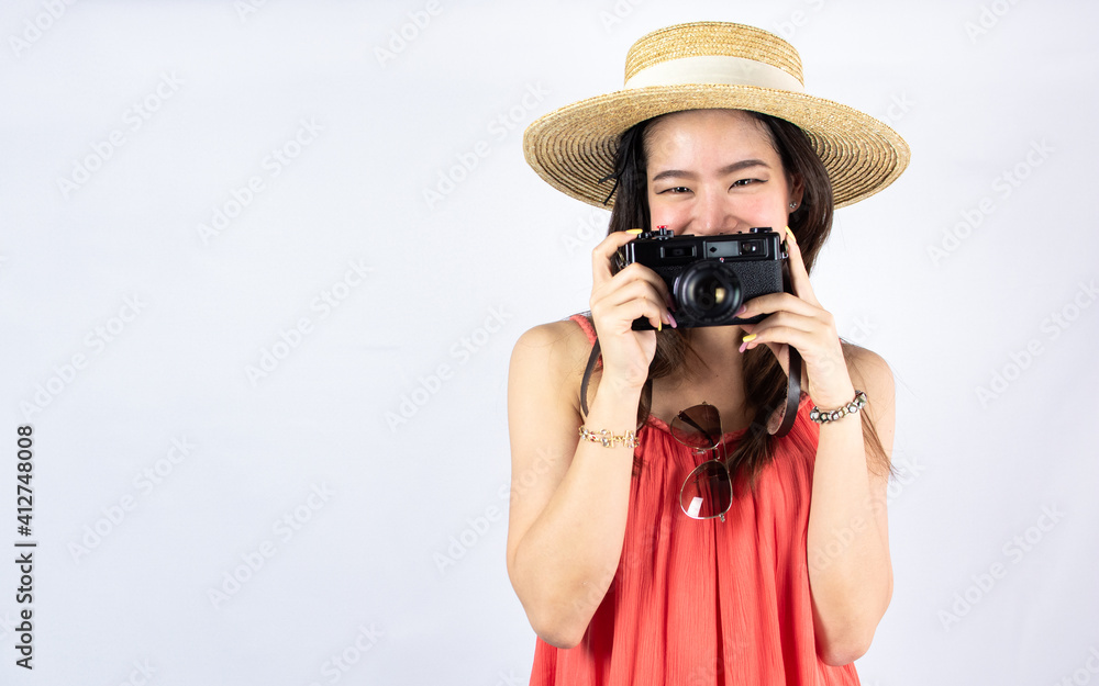 Portrait of asian woman holding camera on white background
