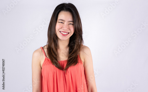 Asian woman smiling and wearing pink shirt for summer vacation