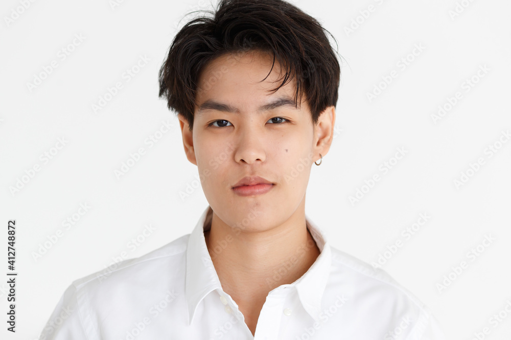 Portrait of a handsome tomboy, a girl who loves to be a man, on white background
