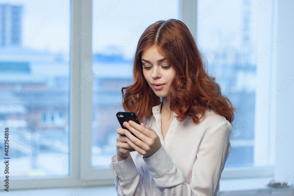 woman manager phones in hands communication office work