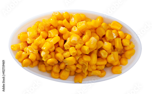 Grains boiled corn on plate. Healthy vegetarian ingredient. Isolated over white background