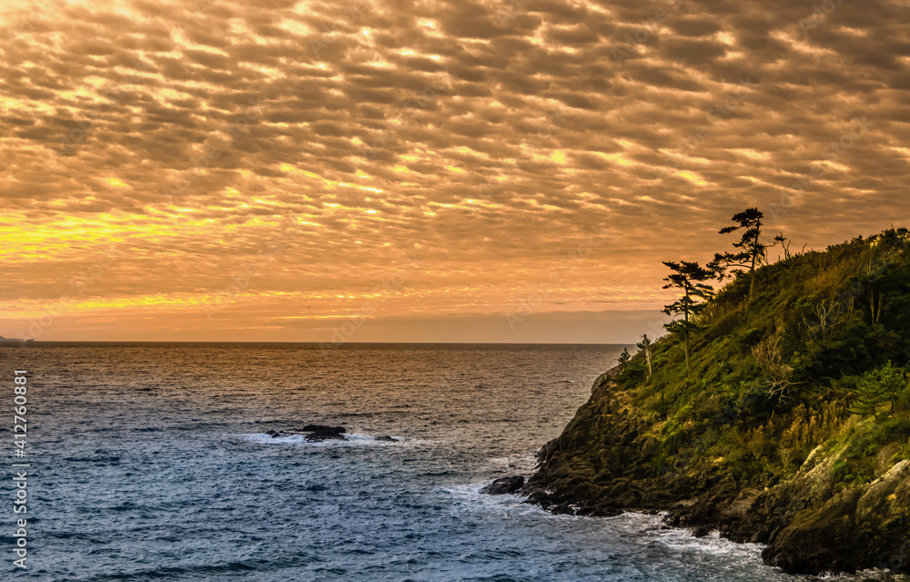 Outcrop as Sun Rises over Pacific Ocean