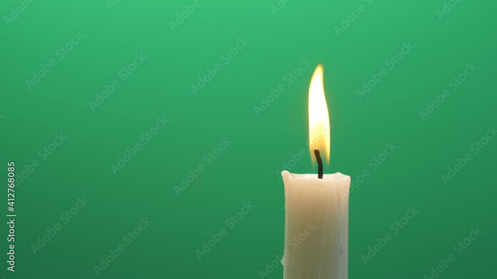 Closeup candle fire flame burning on chroma key green screen background 4K video Closeup candle fire flame burning on chroma key green screen background 4K video
