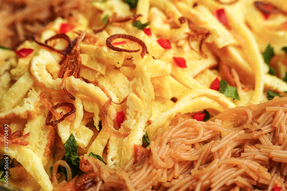 fried vermicelli noodles served with sliced omelet on white background fried vermicelli noodles served with sliced omelet on white background