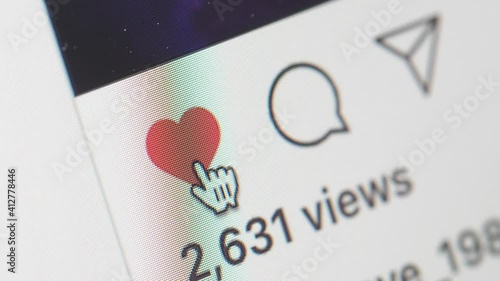 Clicking on the heart like button on social media to show appreciation close-up shot
