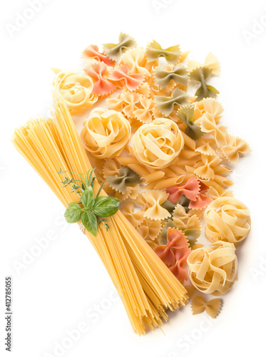 Spaghetti and basil isolated on white background.