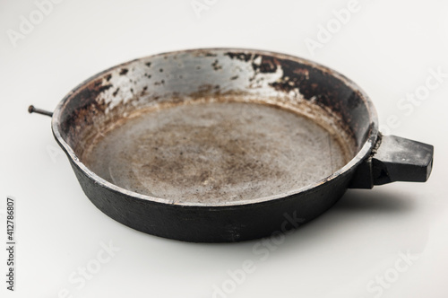 old cast iron frying pan on white background