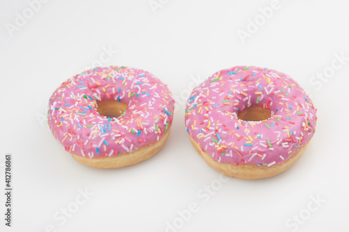 Two pink donuts on a white background