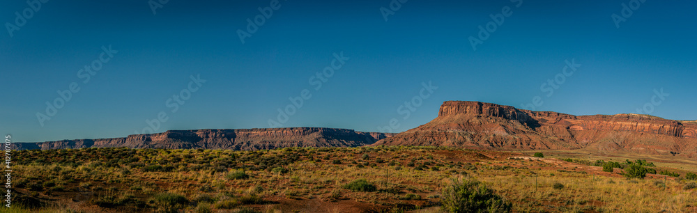 Panorama shot of long orange sandy massif of rock near canyonlands at sunny day in utah, america