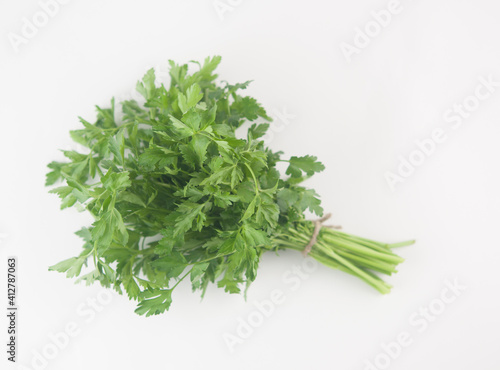Fresh bunch green parsley bunch on white background. Top view, flat lay. Floral design element. Healthy eating and dieting concept