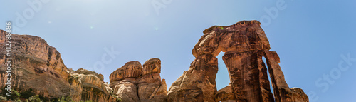 Wide shot of big Druid arch against blue sky in canyonlands national park in Utah, america photo