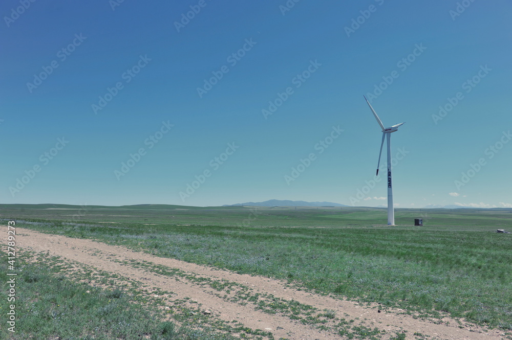 Zhambyl region, Kazakhstan - 05.15.2013 : Wind turbines located in an open hilly area to collect energy. Zhambyl region, Kazakhstan - 05.15.2013 : Wind turbines located in an open hilly area to collect energy.