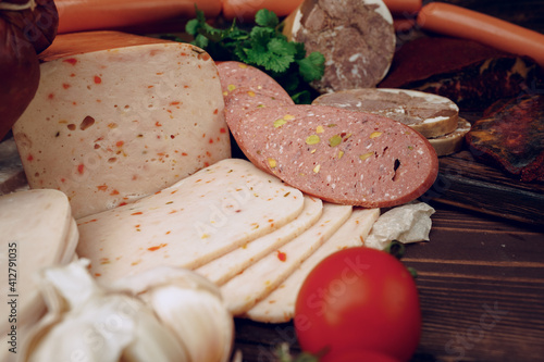 Variety of meat sausages on wooden board