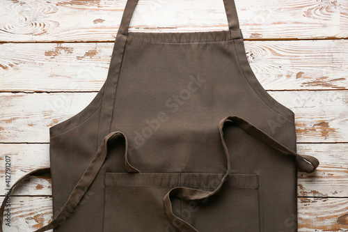 Fotografering Clean apron on wooden background