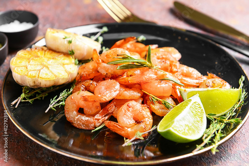 Plate with tasty shrimps on grunge background, closeup