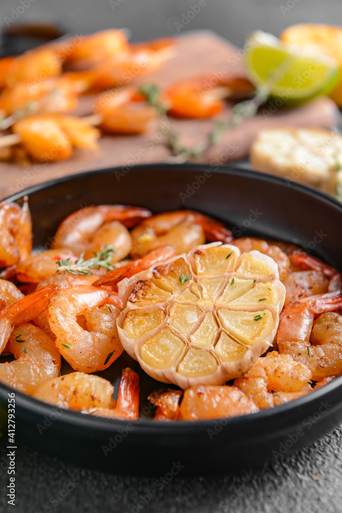 Frying pan with tasty shrimps on table, closeup Frying pan with tasty shrimps on table, closeup