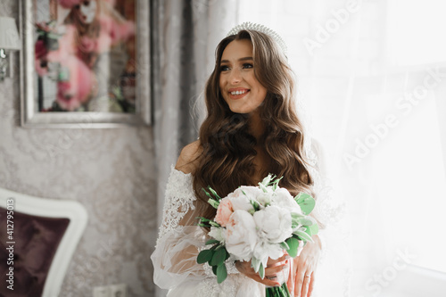 Luxury wedding bride, girl posing and smiling with bouquet © olegparylyak