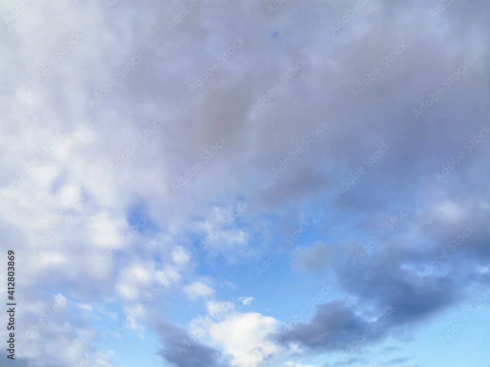 Fototapeta premium Bright blue sky with fluffy cumulus white clouds. Can be used as a design element, natural background.