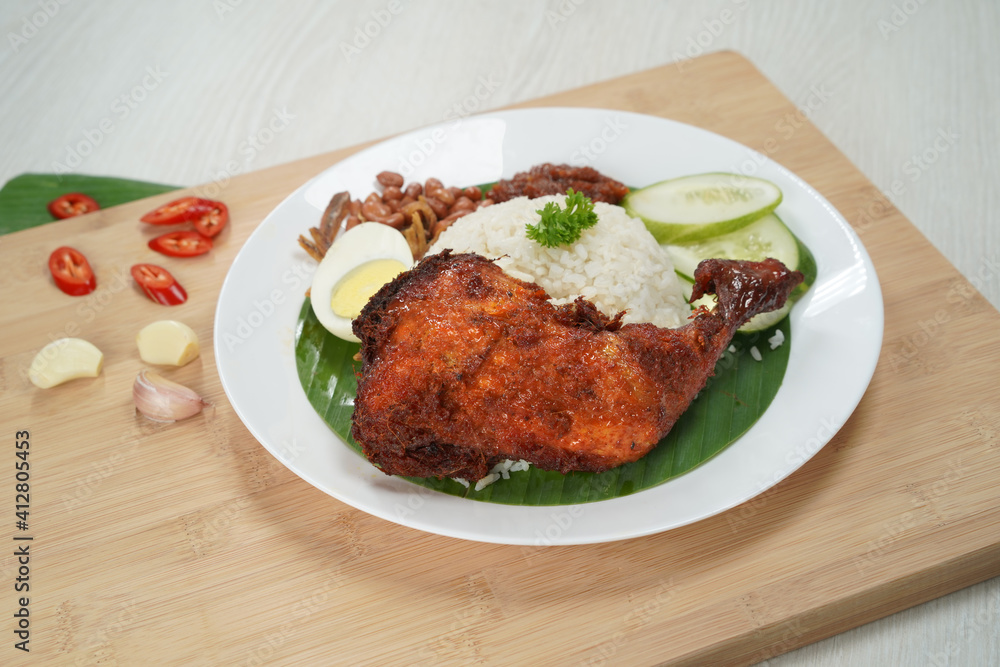 Nasi Lemak dish with chicken drum stick on white wooden verneer Nasi Lemak dish with chicken drum stick on white wooden verneer