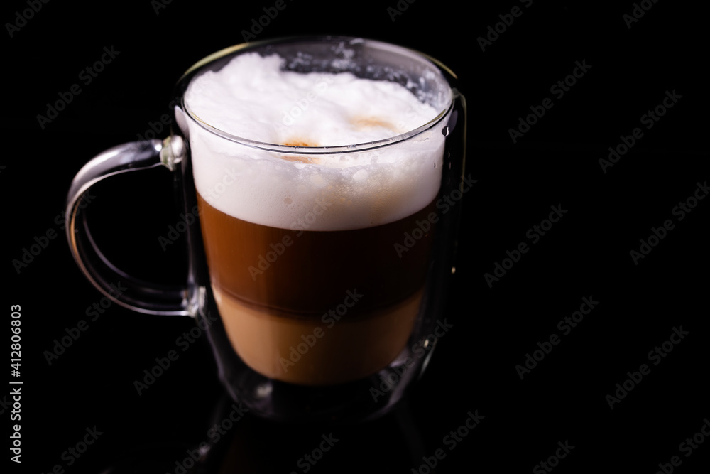 Cappuccino coffee in a transparent cup close-up. Cappuccino coffee in a transparent cup close-up.