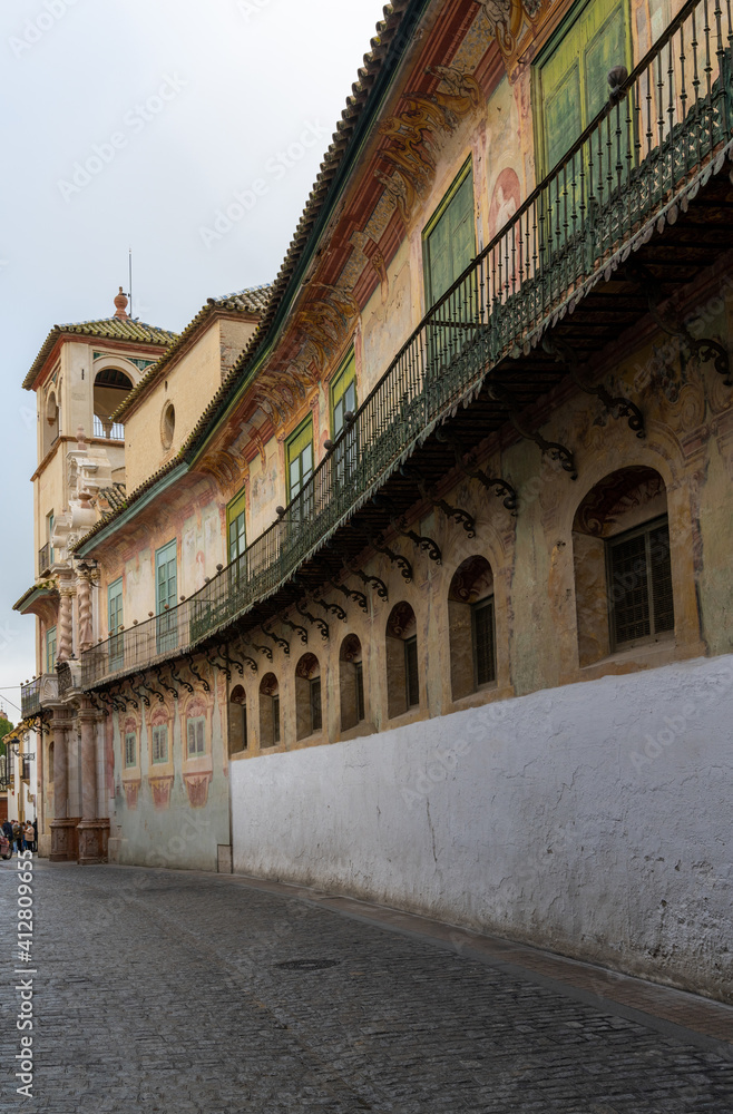 narrow city street in the historic city center of Ecija with the Marquis of Penaflor Palace