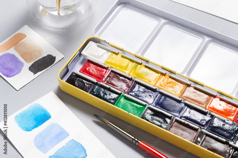 Box of watercolor paints on office desk Box of watercolor paints on office desk