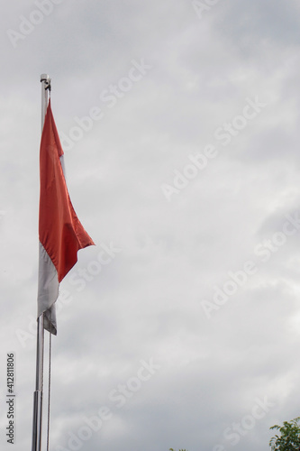 Indonesian flag on the wind with blue sky 