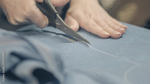 cutting the fabric with sharp scissors. Cut the fabric with tailor's scissors.