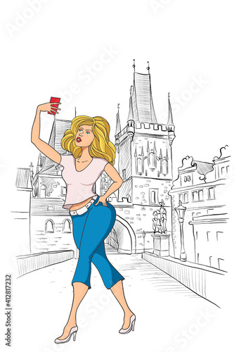 Girl tourist makes selfie in Prague. Lesser Town Bridge Towers on Charles Bridge in the background.