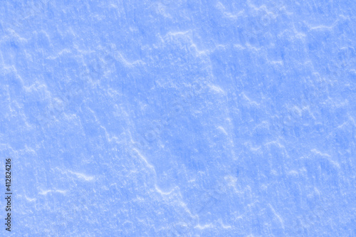 blue texture of an ice surface covered with snow ,cold clear cryslallized wall background ,winter frozen surface close up , abstract macro wallpaper