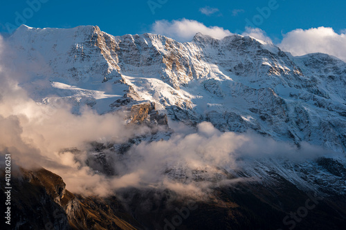 View on the nearby mountains covered with clouds in Mürren village, Switzerland